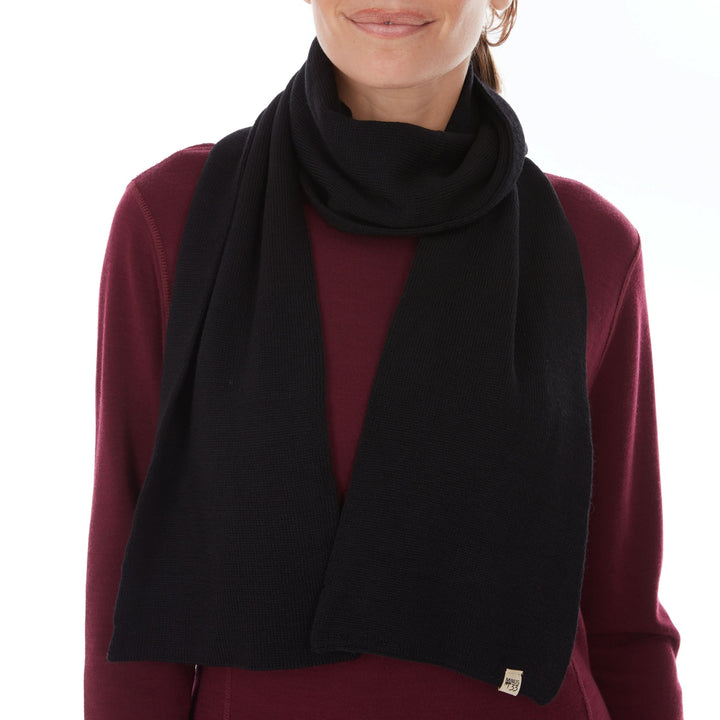 Woman wearing a black midweight merino scarf over a burgundy top 
