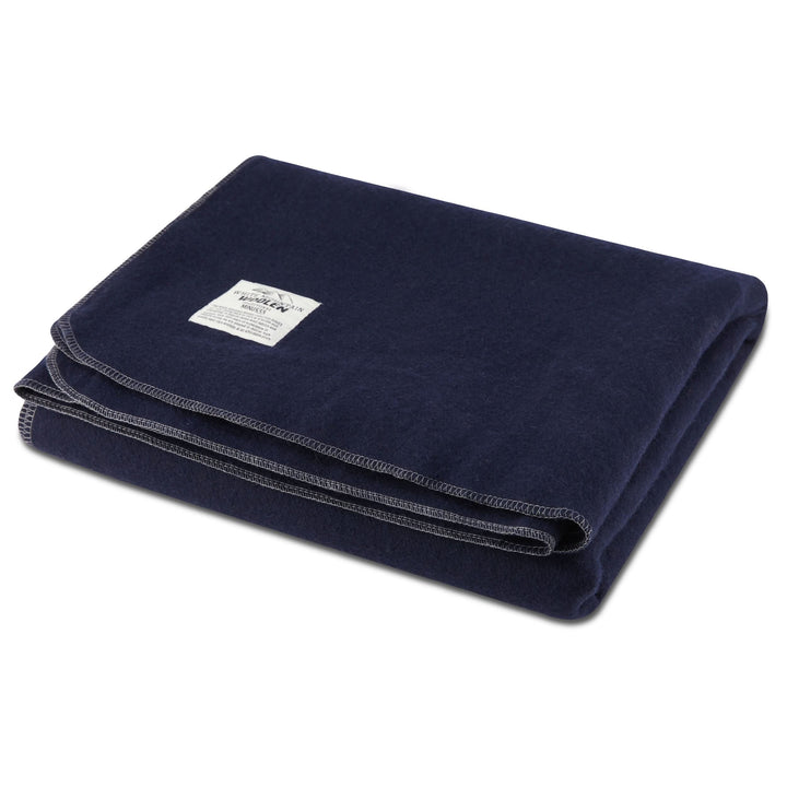 Navy queen wool blanket neatly stacked with contrast stitching 
