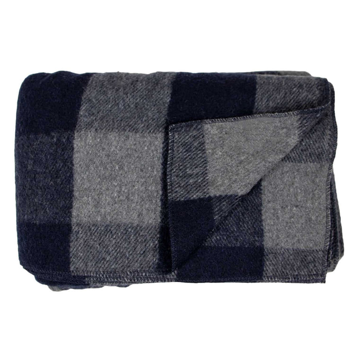 Front view of a folded gray-and-blue buffalo plaid lodge wool blanket, with a corner peeled back to reveal the lighter gray reverse and layered stitched edges 