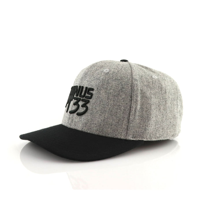 Back three-quarter view of a gray heather baseball cap, showing the curved rear opening, adjustable strap, embroidered Minus33 detail, top button, and stitched crown panels 
