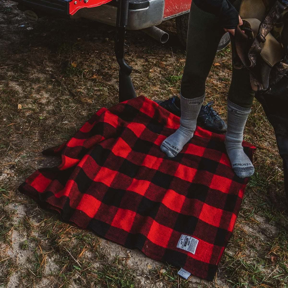 Minus33 Merino Wool Clothing White Mountain Woolen Camp Blanket. Close-up. #color_red-and-black-plaid