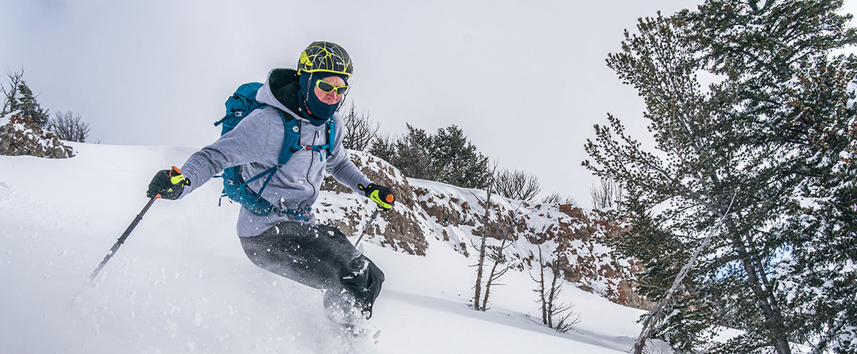 man skiing wearing merino wool hoody and balaclava