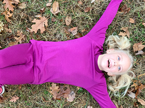 girl playing in midweight kids base layer