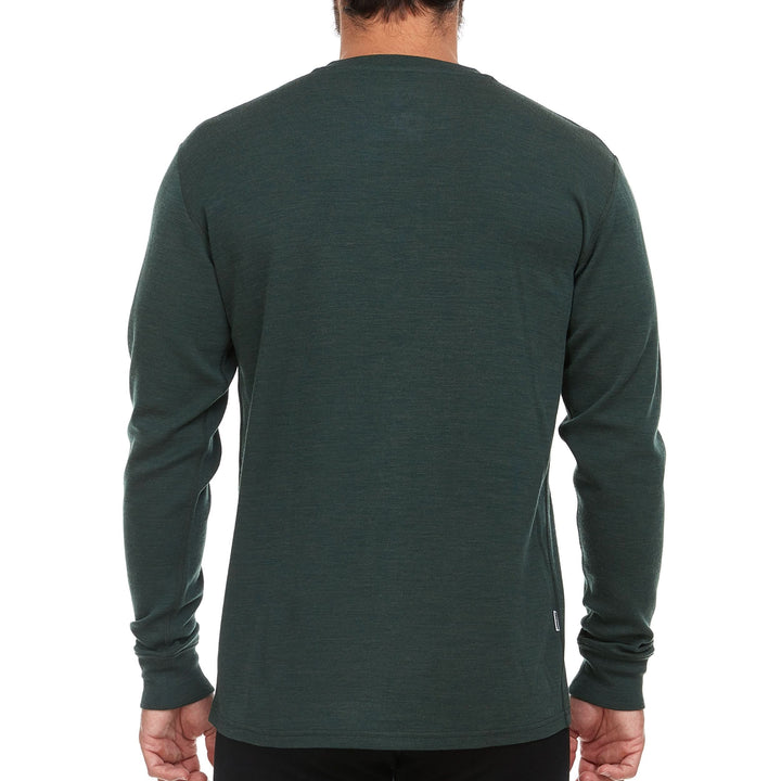 Back view of a man wearing a forest green midweight merino wool long-sleeve henley shirt, showing the smooth crew-neck back, straight shoulder seams, fitted cuffs, and rounded hip-length hem 