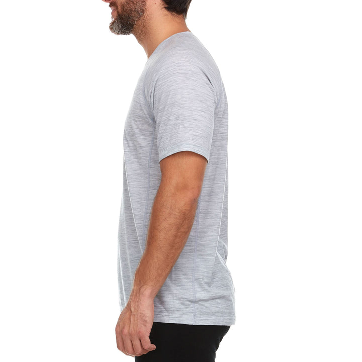 Back view of a man wearing an ash gray Woolverino micro weight merino wool short-sleeve V-neck T-shirt, showing the rear neckline, shoulder seams, fitted sleeves, straight back, and smooth hem 