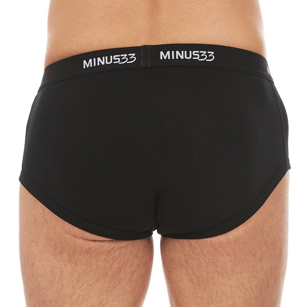 Back close-up from waist to upper thighs of a man wearing black Woolverino micro weight merino wool briefs, showing the elastic waistband, smooth rear panel, high-cut leg openings, and close fit 