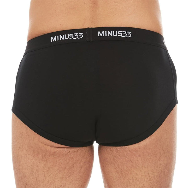 Back close-up from waist to upper thighs of a man wearing black Woolverino micro weight merino wool briefs, showing the elastic waistband, smooth rear panel, high-cut leg openings, and close fit 