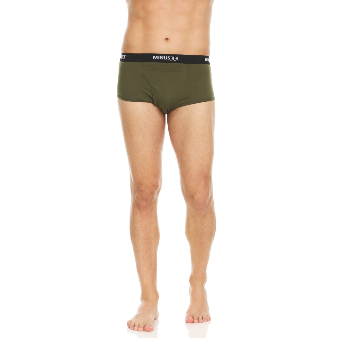 Back view from waist to upper thighs of a man wearing olive drab green Woolverino micro weight merino wool briefs, showing the elastic waistband, smooth rear panel, high-cut leg openings, and close fit 