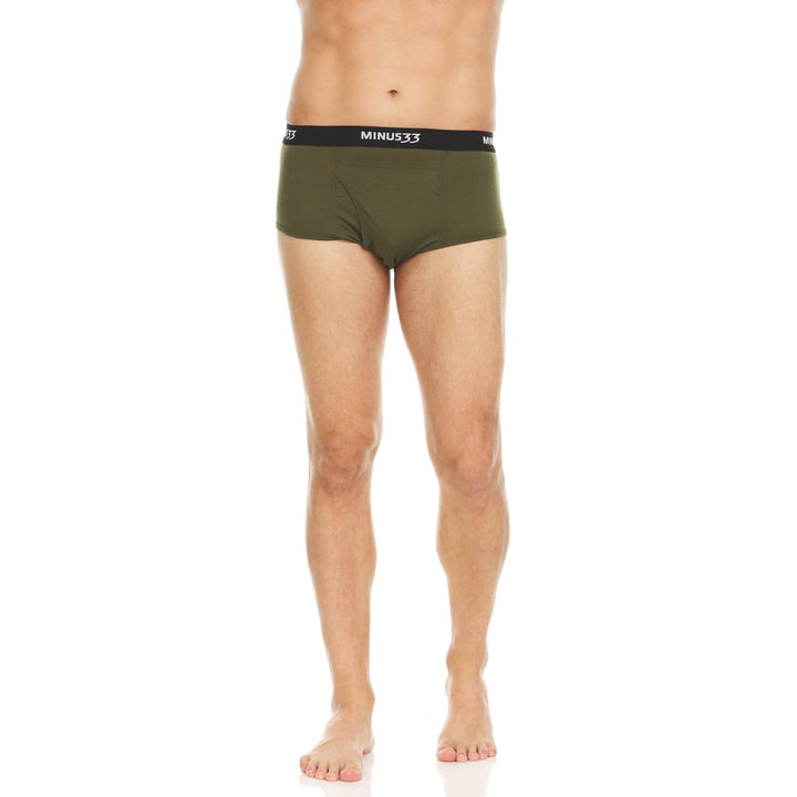 Back view from waist to upper thighs of a man wearing olive drab green Woolverino micro weight merino wool briefs, showing the elastic waistband, smooth rear panel, high-cut leg openings, and close fit 