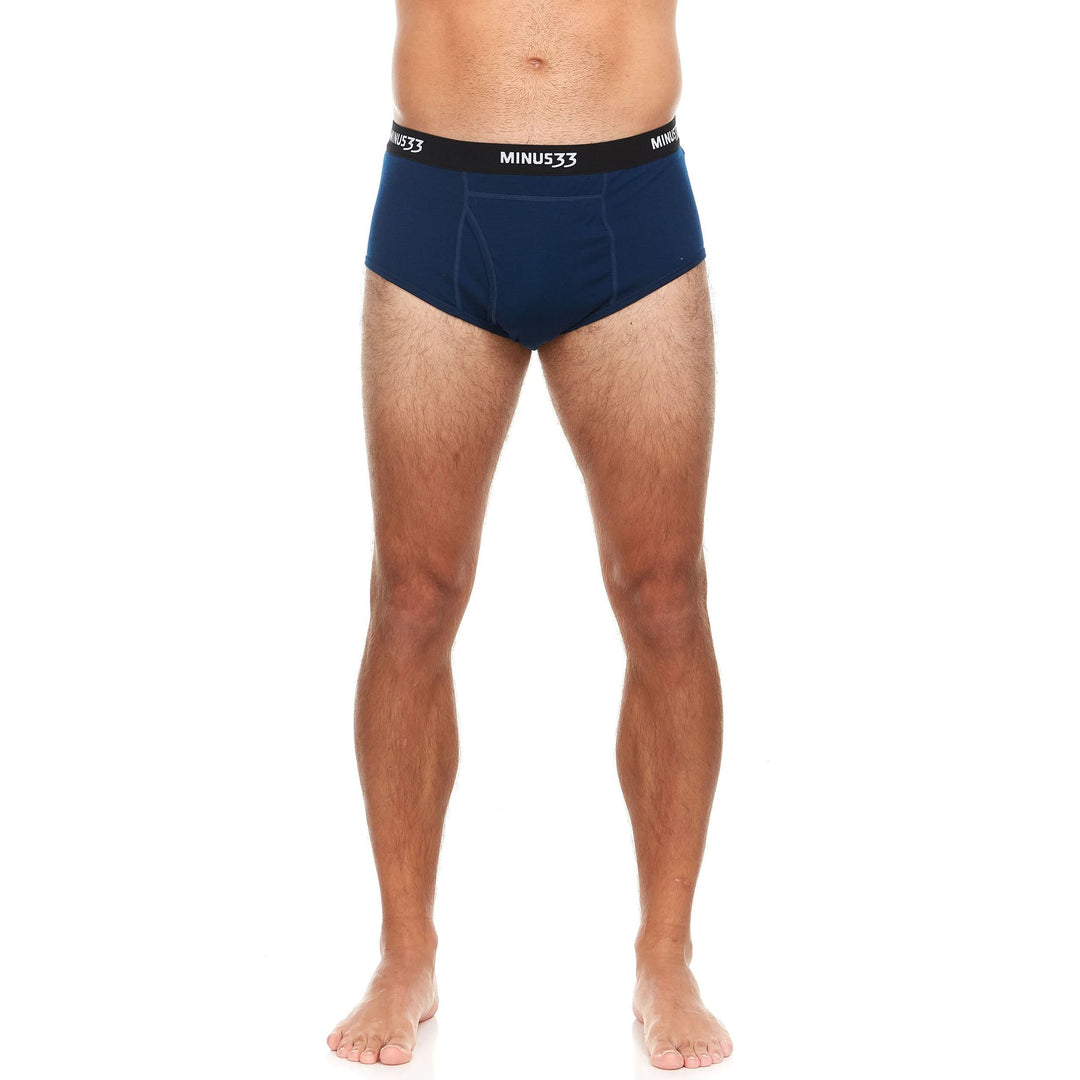 Back view from waist to upper thighs of a man wearing navy Woolverino micro weight merino wool briefs, showing the elastic waistband, smooth rear panel, high-cut leg openings, and close fit 