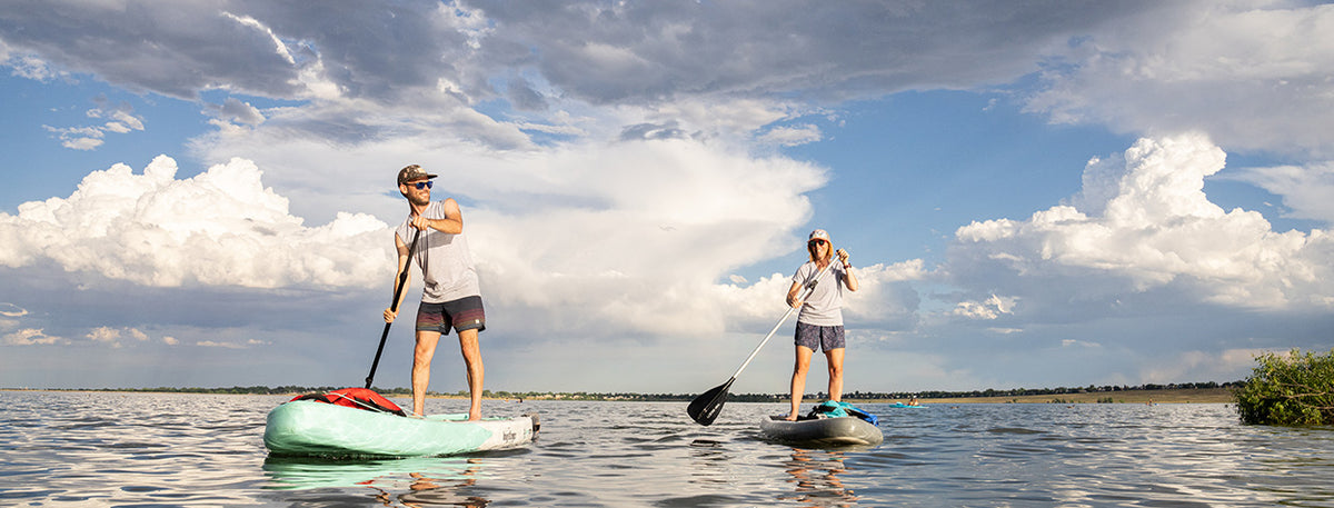 couple paddle boarding wearing micro weight woolverino wool tshirts