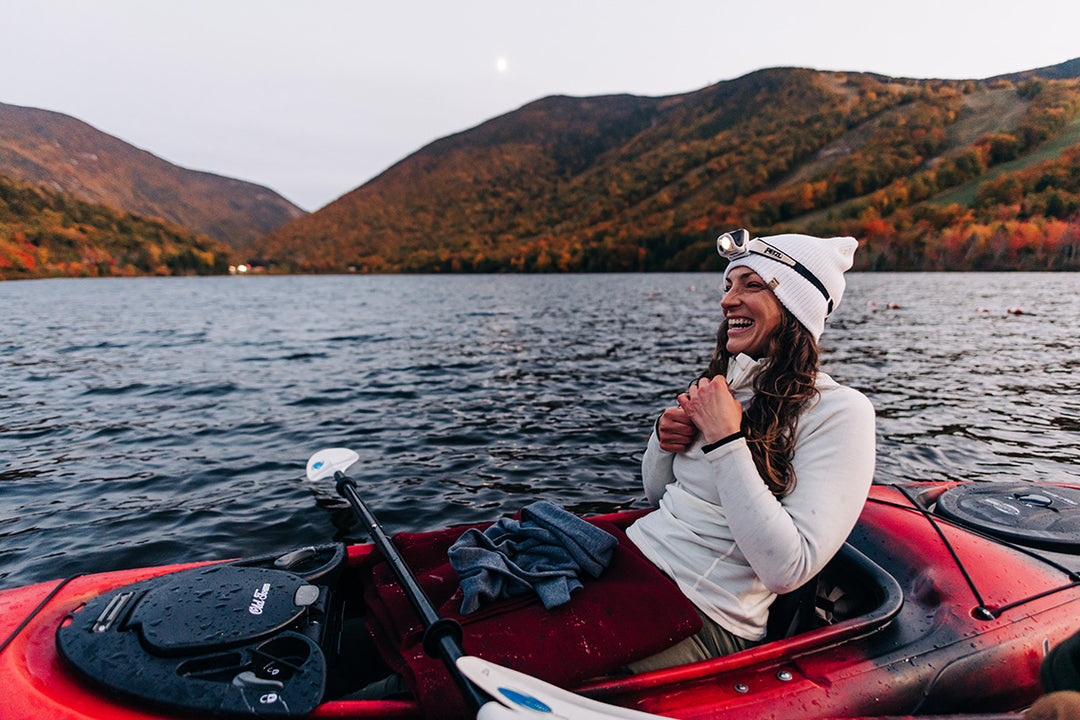 woman kayaking wearing midweight baselayers