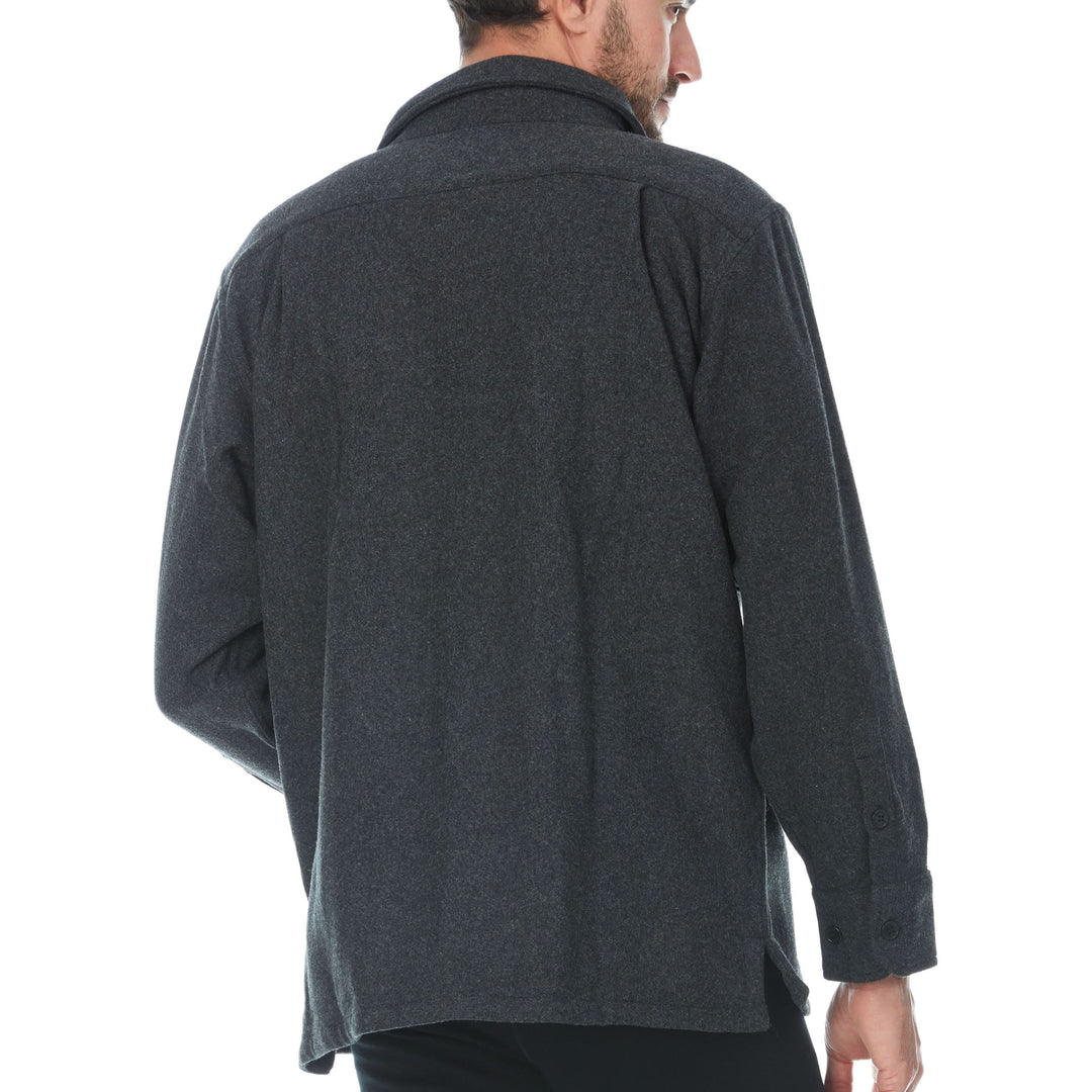 Back three-quarter view of a man modeling a charcoal gray heavy wool guide shirt jacket with a spread collar, long sleeves, button cuffs, and a straight hem 