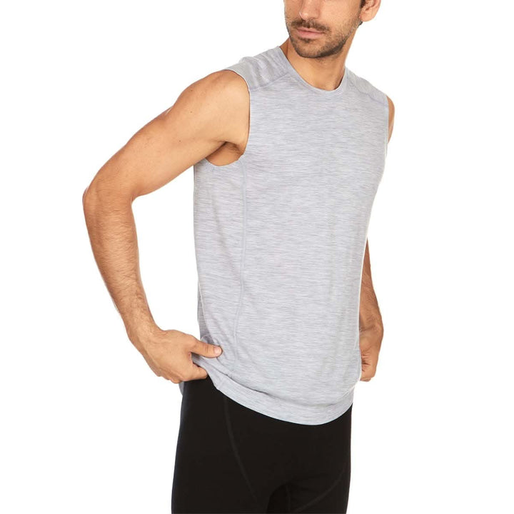 Front view of a man wearing an ash gray Woolverino micro weight merino wool sleeveless crew-neck top, showing the round neckline, broad shoulder panels, sleeveless armholes, straight torso, and hip-length hem 