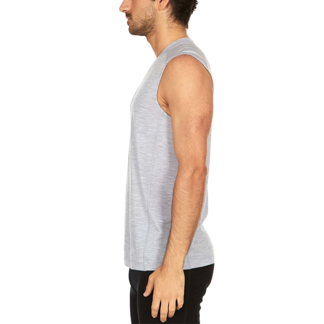 Left side view of a man wearing an ash gray Woolverino micro weight merino wool sleeveless crew-neck top, showing the round neckline, shoulder seam, sleeveless armhole, straight side profile, and hip-length hem 