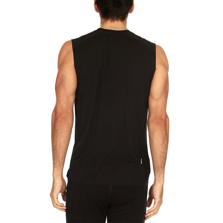 Back view of a man wearing a black Woolverino micro weight merino wool sleeveless crew-neck top, showing the rear neckline, broad shoulder panels, sleeveless armholes, straight back, and hip-length hem 